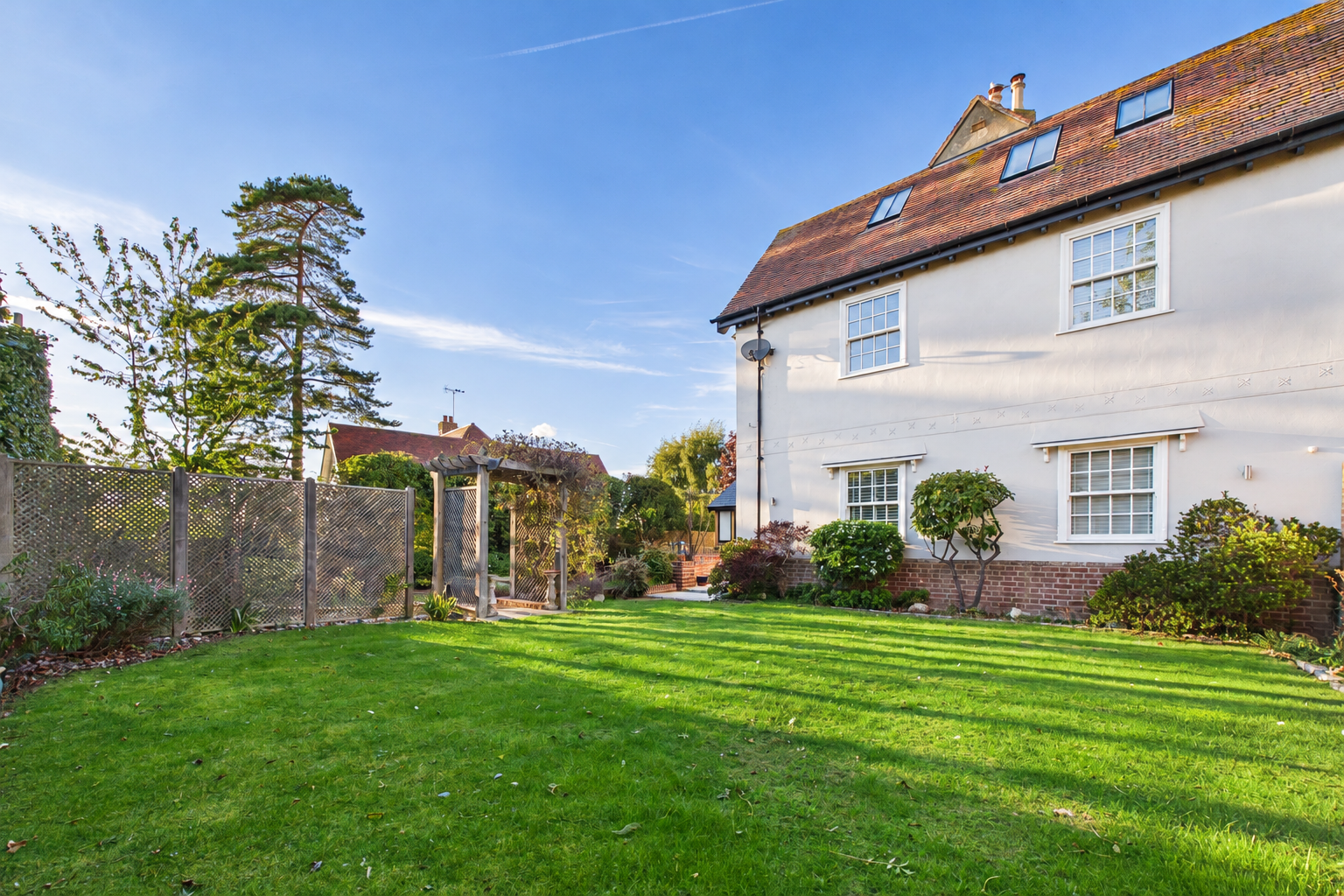 Vibrant English Garden and Cream Stucco House