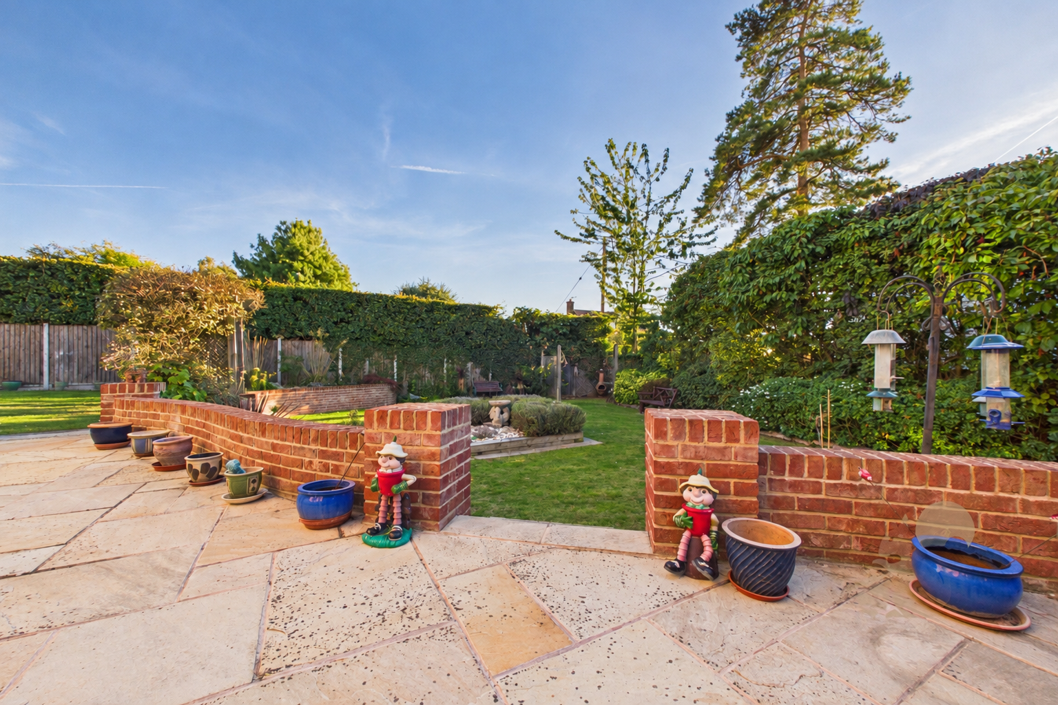 Sunny Backyard Garden with Vibrant Lawn